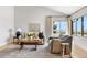 Bright living room featuring a vaulted ceiling, comfortable seating, large windows with scenic views, and wood floors at 6275 Ponderosa Way, Parker, CO 80134