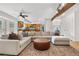 Spacious living room showcasing an open floor plan, comfortable seating, modern lighting, and kitchen access at 6275 Ponderosa Way, Parker, CO 80134