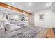 Open-concept living room features a cozy white sectional couch and a decorative rug, great for relaxing and entertaining at 6275 Ponderosa Way, Parker, CO 80134
