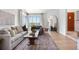 Bright living room boasts large windows, a cozy couch, and stylish decor creating an inviting atmosphere at 6275 Ponderosa Way, Parker, CO 80134