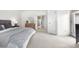 Bright main bedroom boasts a large window, ensuite bathroom, and neutral carpet for a peaceful retreat at 6275 Ponderosa Way, Parker, CO 80134