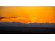 Brilliant Colorado sunset featuring orange skies and majestic mountain silhouettes in the background at 6275 Ponderosa Way, Parker, CO 80134