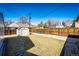 Fully fenced back yard with grass, a gravel area and a storage shed at 3455 Teller St, Wheat Ridge, CO 80033