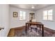 Bright home office with a dark wood desk, neutral colors, and hardwood flooring at 3455 Teller St, Wheat Ridge, CO 80033