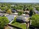 An aerial view captures the property's generous backyard, complemented by mature trees and neighborhood surroundings at 6869 Quay St, Arvada, CO 80003