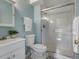 Bathroom with blue walls, step stool, white cabinets and toilet, and glass-enclosed shower at 6869 Quay St, Arvada, CO 80003