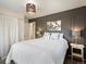 Cozy bedroom featuring a queen size bed, stylish decor, and soft, neutral tones at 6869 Quay St, Arvada, CO 80003
