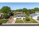 Charming single-Gathering home with green lawn, mature trees, and a lovely white front door at 6869 Quay St, Arvada, CO 80003