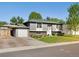 Charming home featuring a manicured front lawn and attached garage, perfect for comfortable living at 6869 Quay St, Arvada, CO 80003