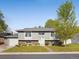 Inviting home exterior features a well-maintained lawn and tasteful landscaping, enhancing curb appeal at 6869 Quay St, Arvada, CO 80003
