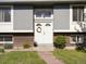 Inviting front entrance with double doors, wreath, and well-maintained landscaping at 6869 Quay St, Arvada, CO 80003