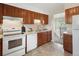 Well-lit kitchen with updated appliances, granite countertops, and ample cabinet space at 6869 Quay St, Arvada, CO 80003