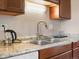 A close up of a kitchen sink with a faucet and counter with granite at 6869 Quay St, Arvada, CO 80003