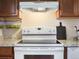 Functional kitchen with white appliances, granite countertops, and stylish decor at 6869 Quay St, Arvada, CO 80003