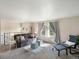 Bright living area with comfortable seating, large window, and neutral color palette at 6869 Quay St, Arvada, CO 80003