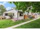 Exterior shot of a well-maintained property, showcasing its landscaped yard and charming outdoor patio at 8314 S Everett Way # B, Littleton, CO 80128