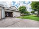 View of the garage, driveway, and manicured lawn surrounding the property at 8314 S Everett Way # B, Littleton, CO 80128