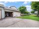 View of the garage, driveway, and manicured lawn surrounding the property at 8314 S Everett Way # B, Littleton, CO 80128