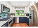 Modern kitchen featuring stainless steel appliances, blue cabinets, and an eat-in breakfast nook at 8314 S Everett Way # B, Littleton, CO 80128