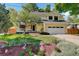 Inviting two-story home with a well-manicured front yard, mature trees, and a two-car garage at 1620 Oak Ave, Boulder, CO 80304