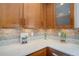 Close up view of the updated kitchen countertop with stylish tile backsplash and light wood cabinets at 1620 Oak Ave, Boulder, CO 80304