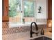 Stylish kitchen sink area with hexagon backsplash, stainless steel sink, and modern faucet at 1620 Oak Ave, Boulder, CO 80304