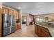 Well-equipped kitchen with stainless steel appliances and wood cabinets at 8171 S Catawba Ct, Aurora, CO 80016