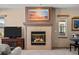 Cozy living room featuring a fireplace and ample natural light at 8171 S Catawba Ct, Aurora, CO 80016
