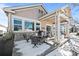 Covered patio with seating area and snow covered backyard at 8171 S Catawba Ct, Aurora, CO 80016