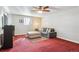 Cozy basement living room with an ottoman, ceiling fan, and comfy sofa with throw pillows at 1640 Quince St, Denver, CO 80220