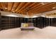 Finished basement featuring custom shelving, soft lighting, and a cozy seating area, perfect for relaxation at 28890 Pinewood Vista Dr, Evergreen, CO 80439
