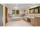 Spacious bathroom with a soaking tub, skylight, and charming wooden accents at 28890 Pinewood Vista Dr, Evergreen, CO 80439
