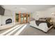 Light-filled bedroom with a fireplace and balcony offering scenic views of the surrounding landscape at 28890 Pinewood Vista Dr, Evergreen, CO 80439