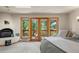Bright bedroom featuring a fireplace and balcony with scenic outdoor views at 28890 Pinewood Vista Dr, Evergreen, CO 80439