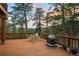 Outdoor deck with forest view, a dining set and fireplace create the perfect gathering spot at 28890 Pinewood Vista Dr, Evergreen, CO 80439