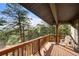Inviting deck with wooden railings, offering serene views of the surrounding forest at 28890 Pinewood Vista Dr, Evergreen, CO 80439