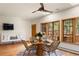 Bright dining area with wooden table, stylish chairs, and views of the surrounding trees and private deck at 28890 Pinewood Vista Dr, Evergreen, CO 80439