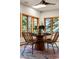 Cozy dining area with a stylish table, seating for four, and scenic outdoor views through large picture windows at 28890 Pinewood Vista Dr, Evergreen, CO 80439