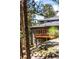 Exterior of home featuring a walkout patio, neutral paint color, and tall trees in the surrounding yard at 28890 Pinewood Vista Dr, Evergreen, CO 80439