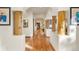 Bright hallway with hardwood floors and unique wooden pillars leading to other rooms at 28890 Pinewood Vista Dr, Evergreen, CO 80439