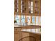 Close up view of a sink with cabinets and window with view in kitchen at 28890 Pinewood Vista Dr, Evergreen, CO 80439
