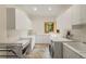 Well-lit laundry room with ample counter space and modern washer and dryer at 28890 Pinewood Vista Dr, Evergreen, CO 80439