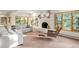 Bright living room with a cozy fireplace, large windows with views, and comfortable seating at 28890 Pinewood Vista Dr, Evergreen, CO 80439