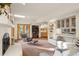Spacious living room featuring a fireplace, built-in shelving, and access to an outdoor deck at 28890 Pinewood Vista Dr, Evergreen, CO 80439