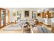 Bright living room showcases a cozy sofa, stylish decor, and large windows offering natural light and tree views at 28890 Pinewood Vista Dr, Evergreen, CO 80439