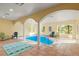 Indoor pool with tile flooring, bright lighting, and large windows offering picturesque views of the surrounding landscape at 28890 Pinewood Vista Dr, Evergreen, CO 80439