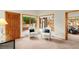 Sitting area with two chairs, view from large windows, and entry into another bedroom at 28890 Pinewood Vista Dr, Evergreen, CO 80439