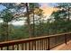 Scenic view from the deck, featuring beautiful evergreens against a breathtaking sunset sky at 28890 Pinewood Vista Dr, Evergreen, CO 80439