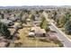 Aerial view showcasing the property, mature trees, fenced yard, and surrounding neighborhood at 5200 W Ottawa Ave, Littleton, CO 80128