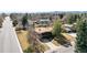 Aerial view of the property showcasing its well-manicured lawn, mature trees, and surrounding neighborhood at 5200 W Ottawa Ave, Littleton, CO 80128